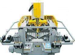 Massive vertical saw head mitering system tilts left to right to a full 60 degrees. Automatic controlled via CNC unit.